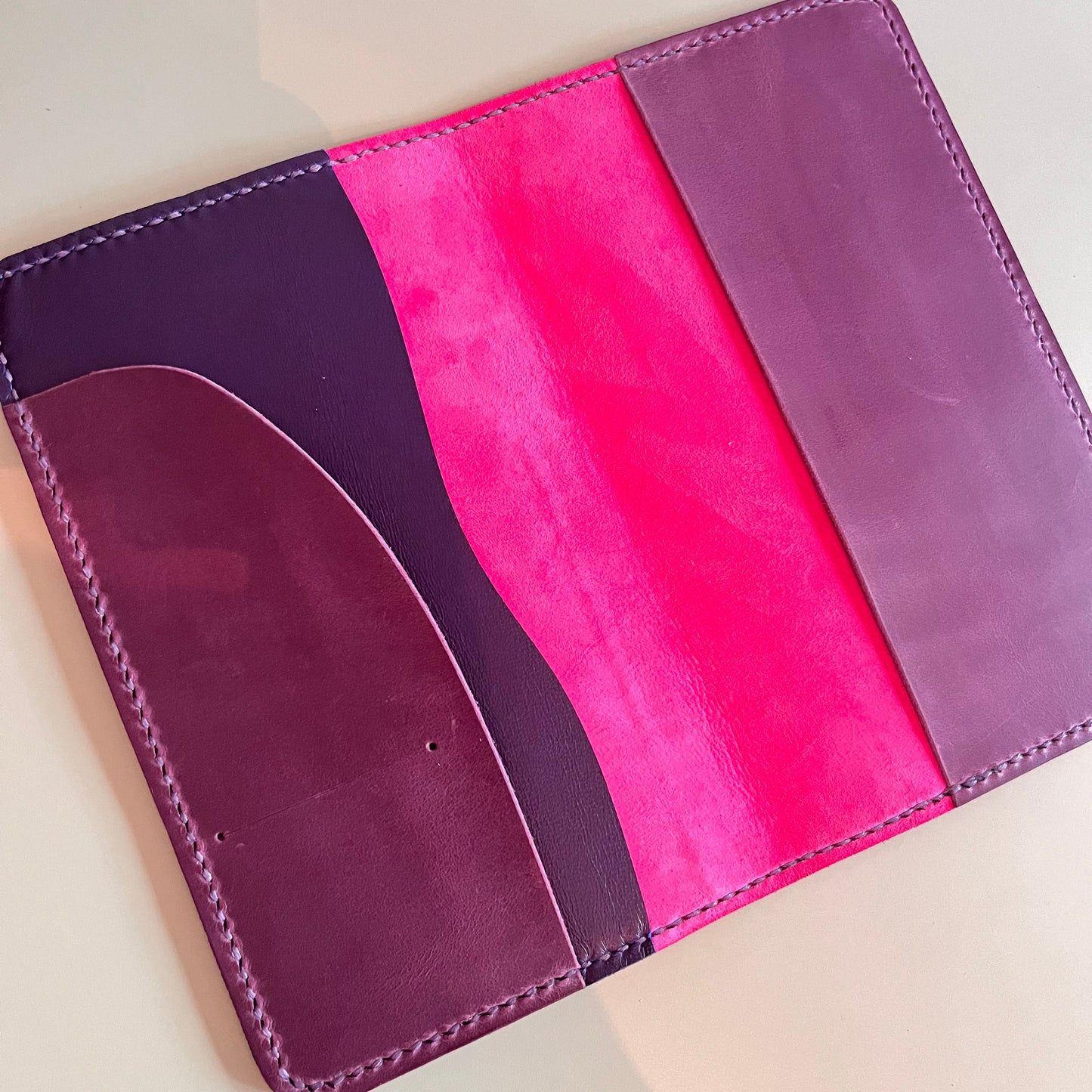 Open view of TN Aris leather cover with Fuchsia lining and Blueberry insert pocket