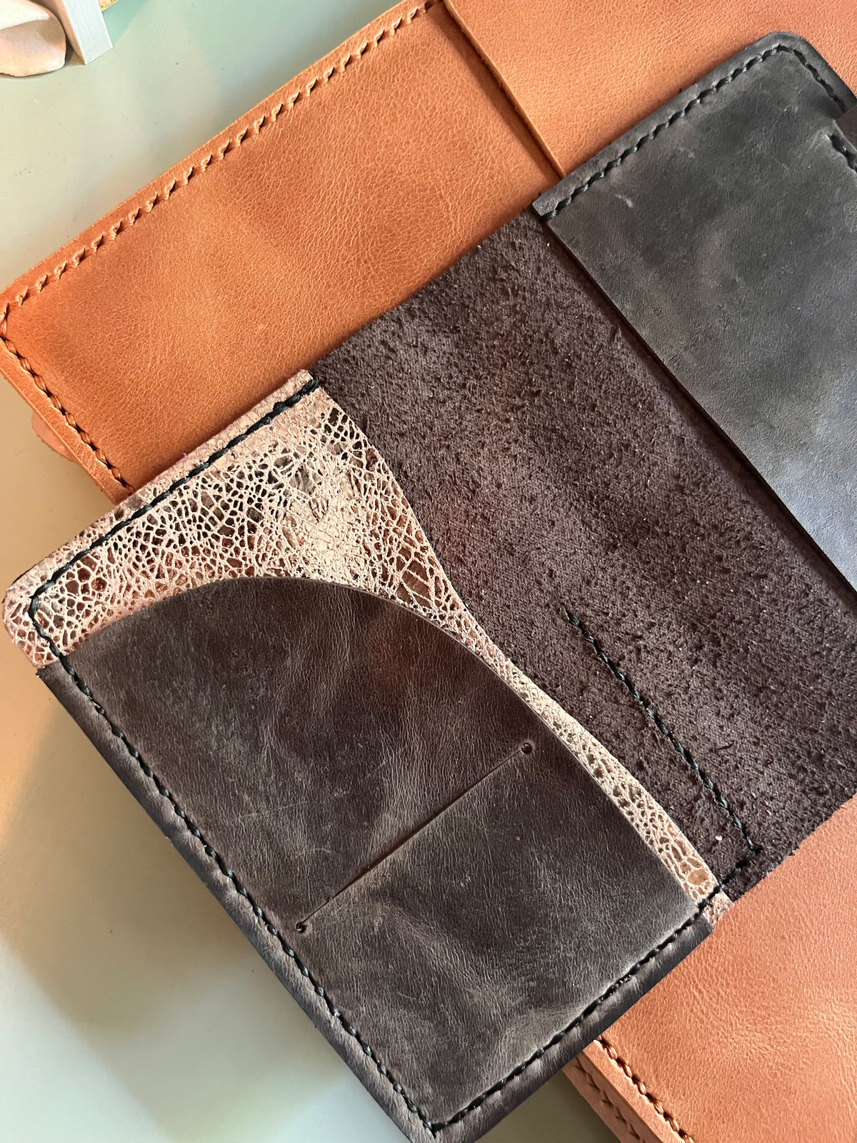 Passport size in coal leather open flat