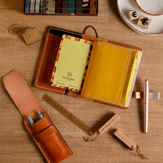 Handmade leather cover with notebook inserts for a Traveler’s Notebook style setup