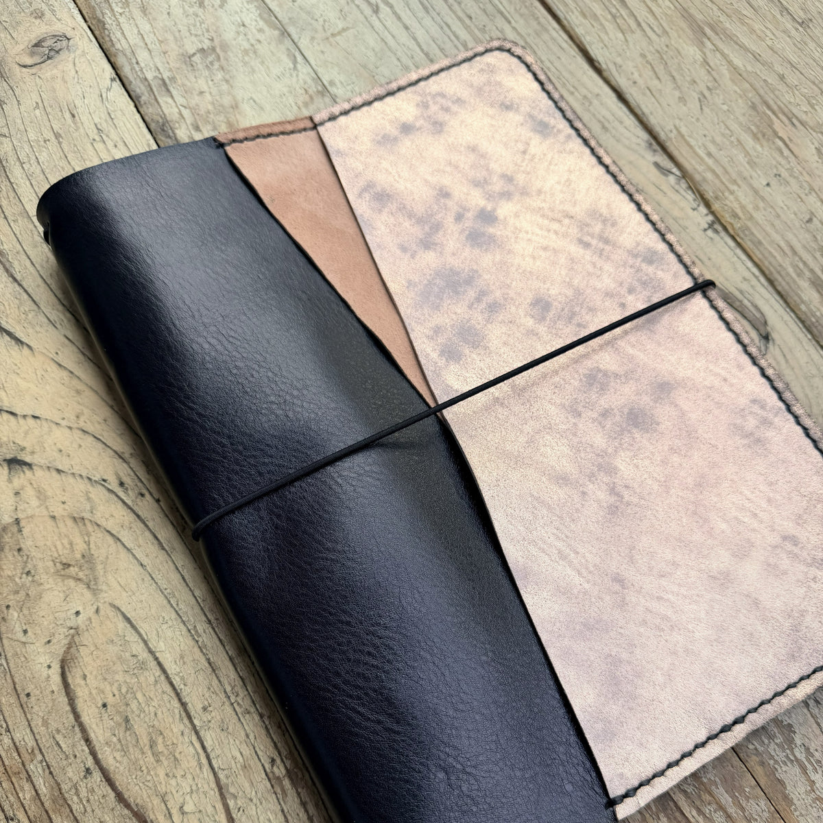 A5 size leather planner cover in Nero angled view