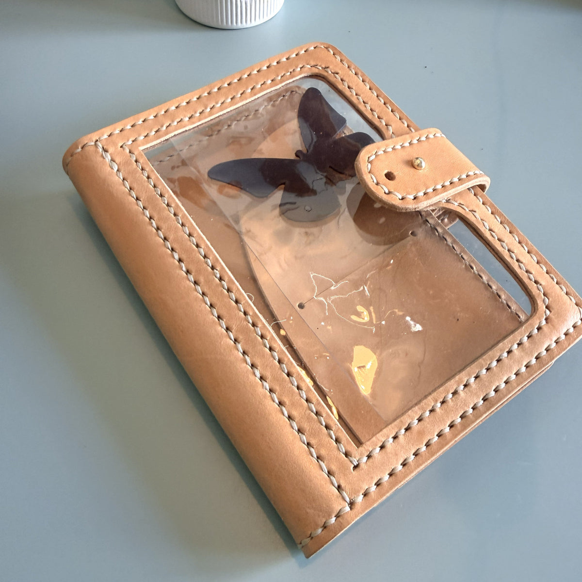 Angled view of A6 Areti leather cover with transparent window pocket