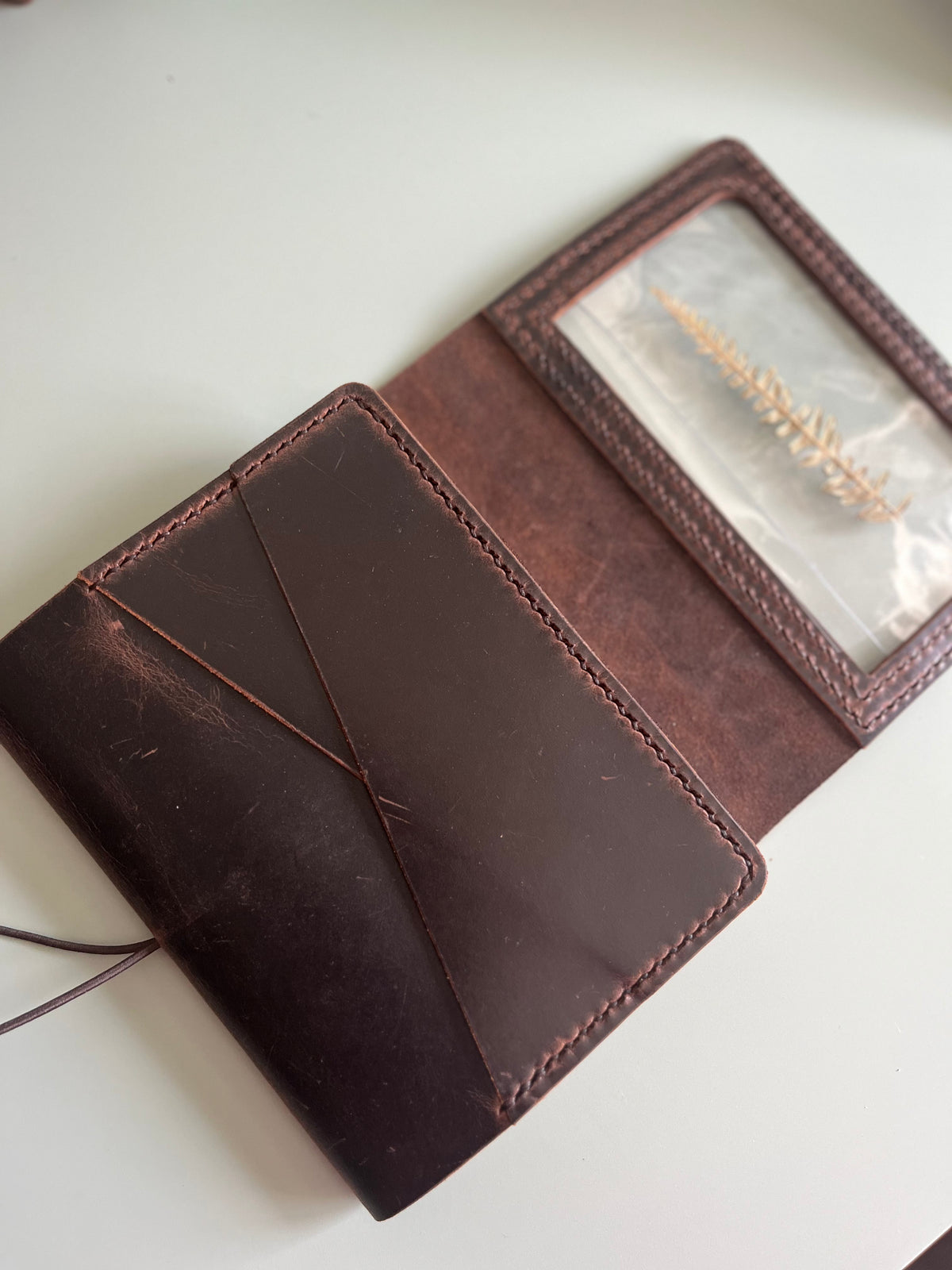 Angled view of A6 Areti Trifold Reverse leather cover with interior pockets