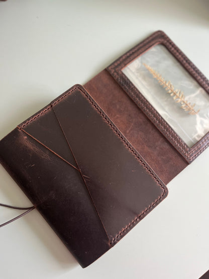 Angled view of A6 Areti Trifold Reverse leather cover with interior pockets