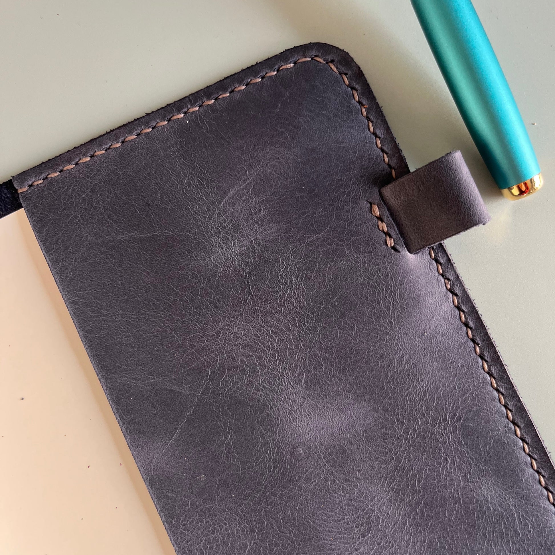 Detail of  Midnight A5 leather cover with a pen loop
