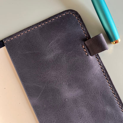 Detail of  Midnight A5 leather cover with a pen loop