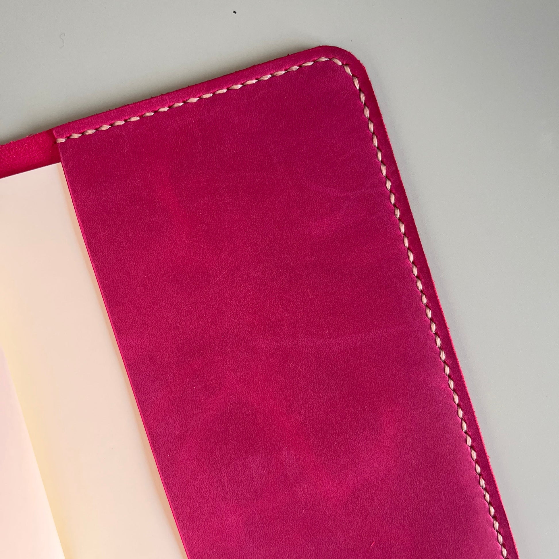 Detail of Heather accent pocket on Raspberry A5 leather cover
