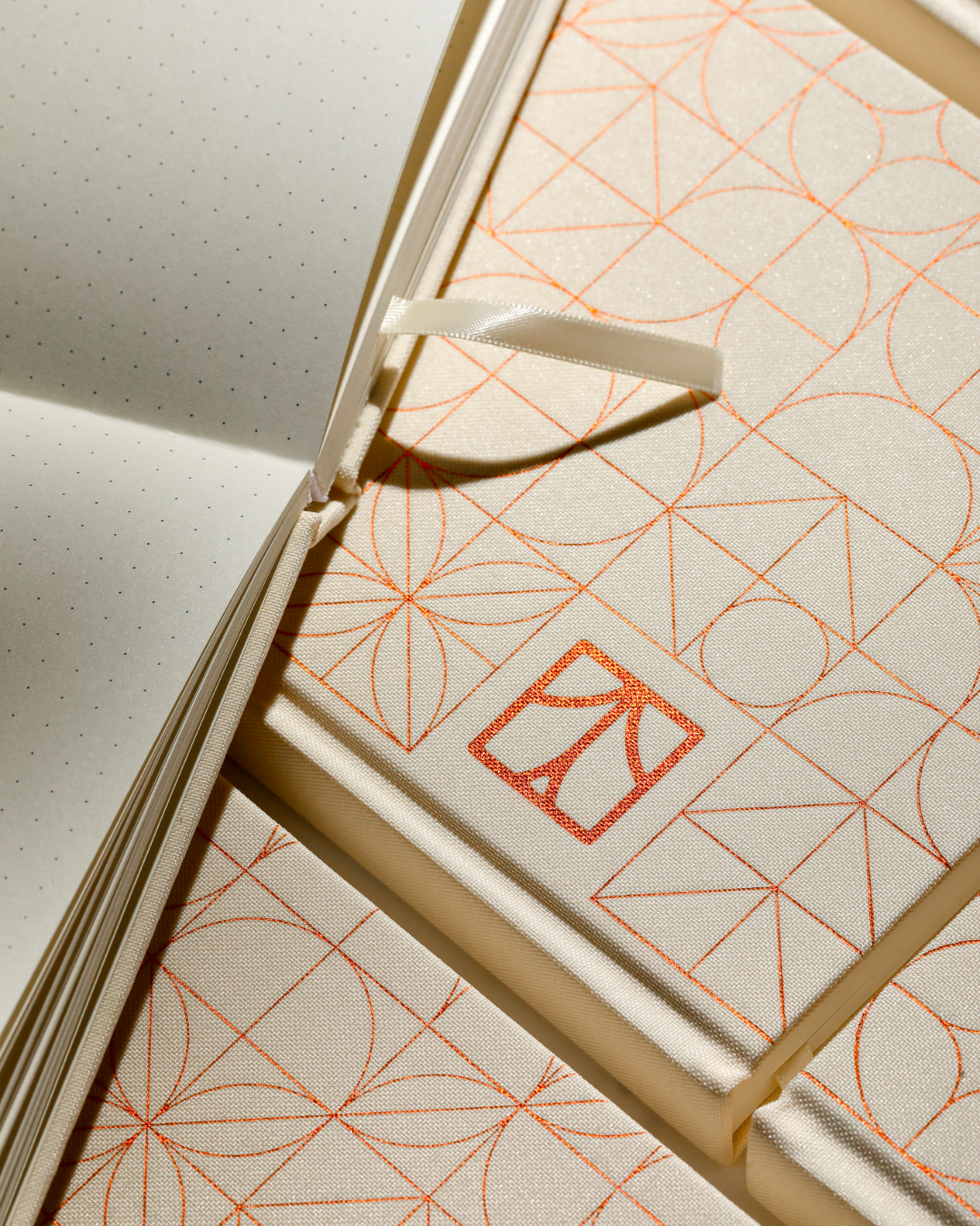 Open A5 bullet journal with warm ivory dot grid pages