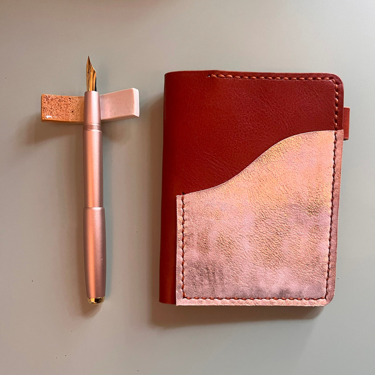 Passport cover in Ruggine leather with Salmon platina outer pocket closed view