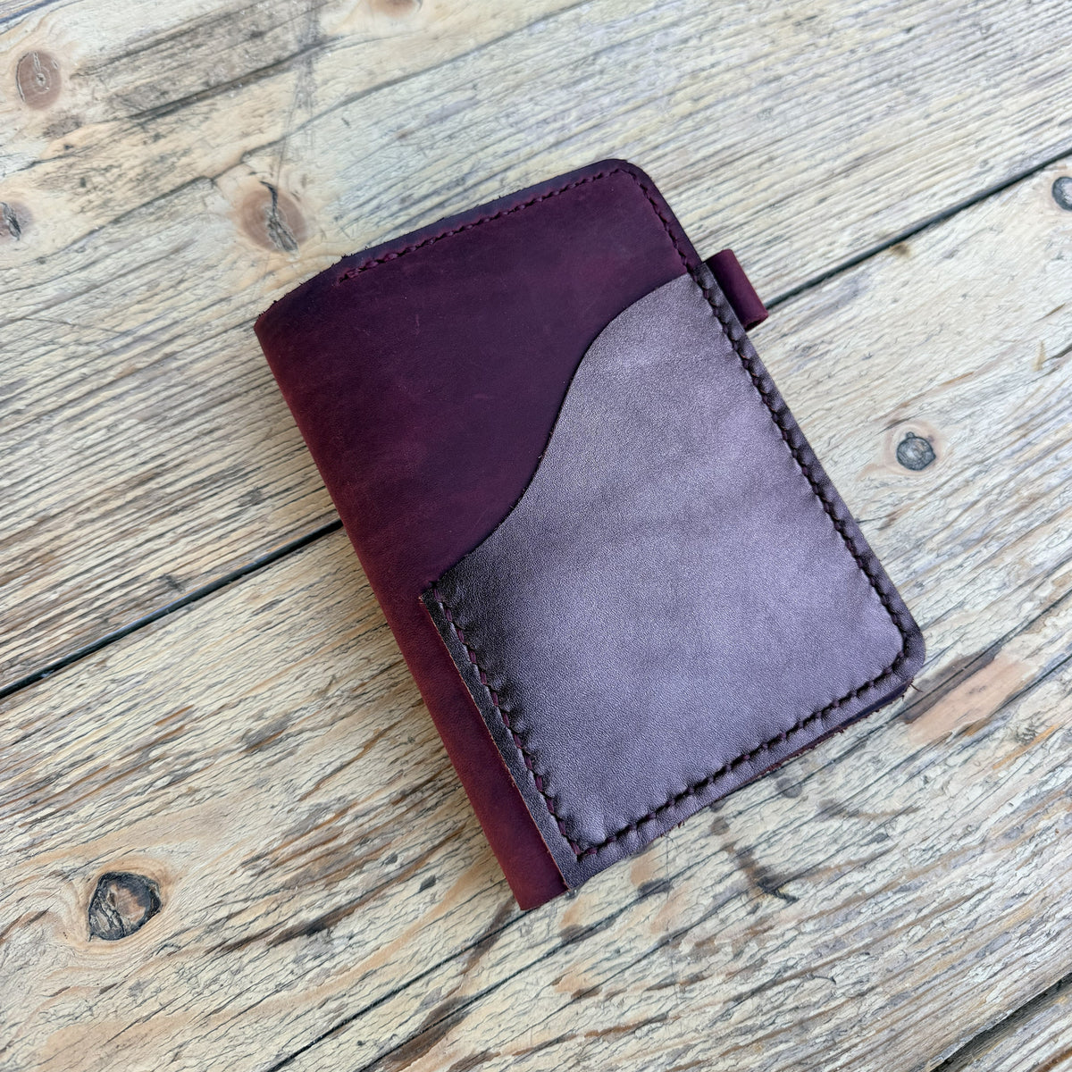 Passport size in beetroot leather angled view