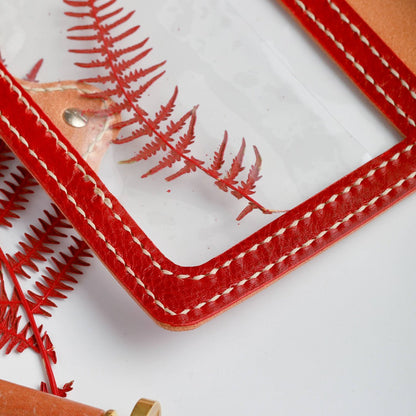Transparent window pocket detail on Rosso Areti leather planner cover