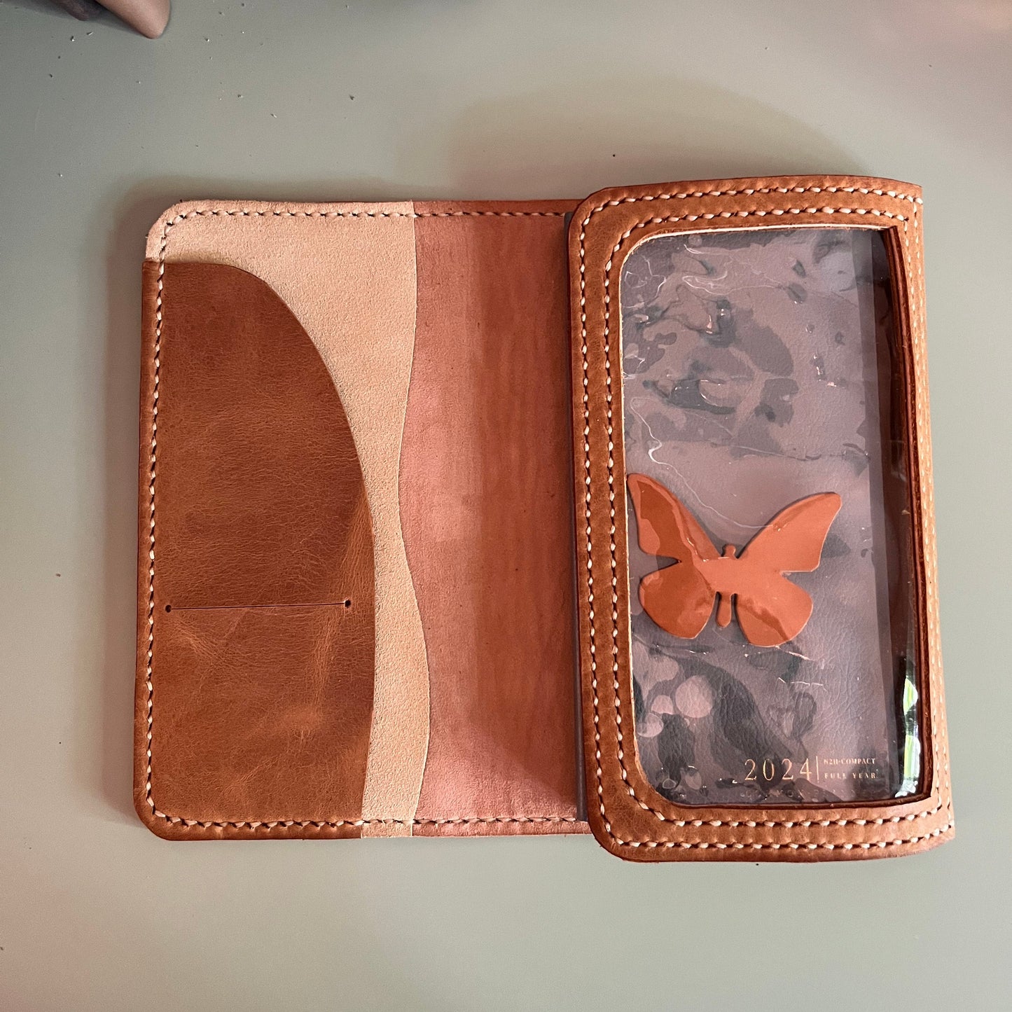 Reverse view of Weeks Areti trifold leather cover with Deep Salmon details